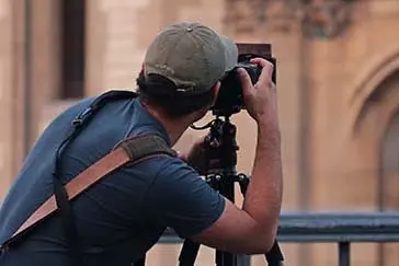 A man taking a photo using a digital camera.