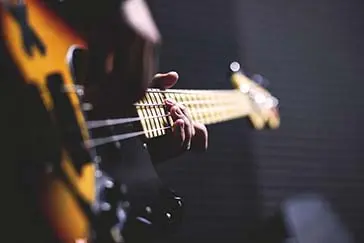 Playing a guitar.